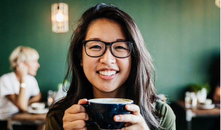 Lady smiling with a cup of coffe